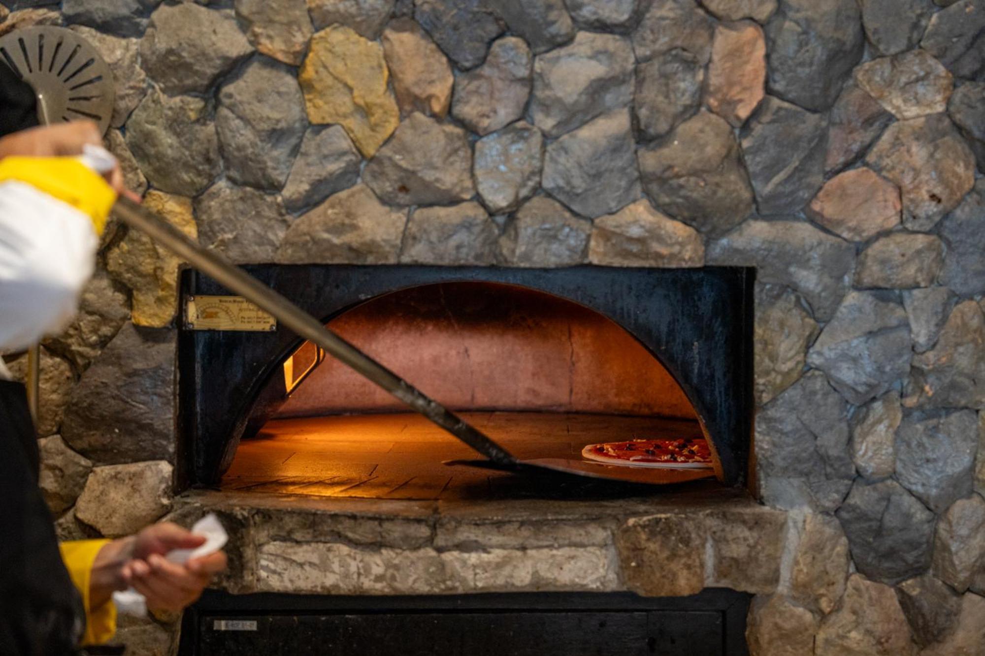 Dusit Thani Krabi Beach Resort - Sha Extra Plus Klong Muang Beach Exterior foto A pizza being removed from a wood-fired oven